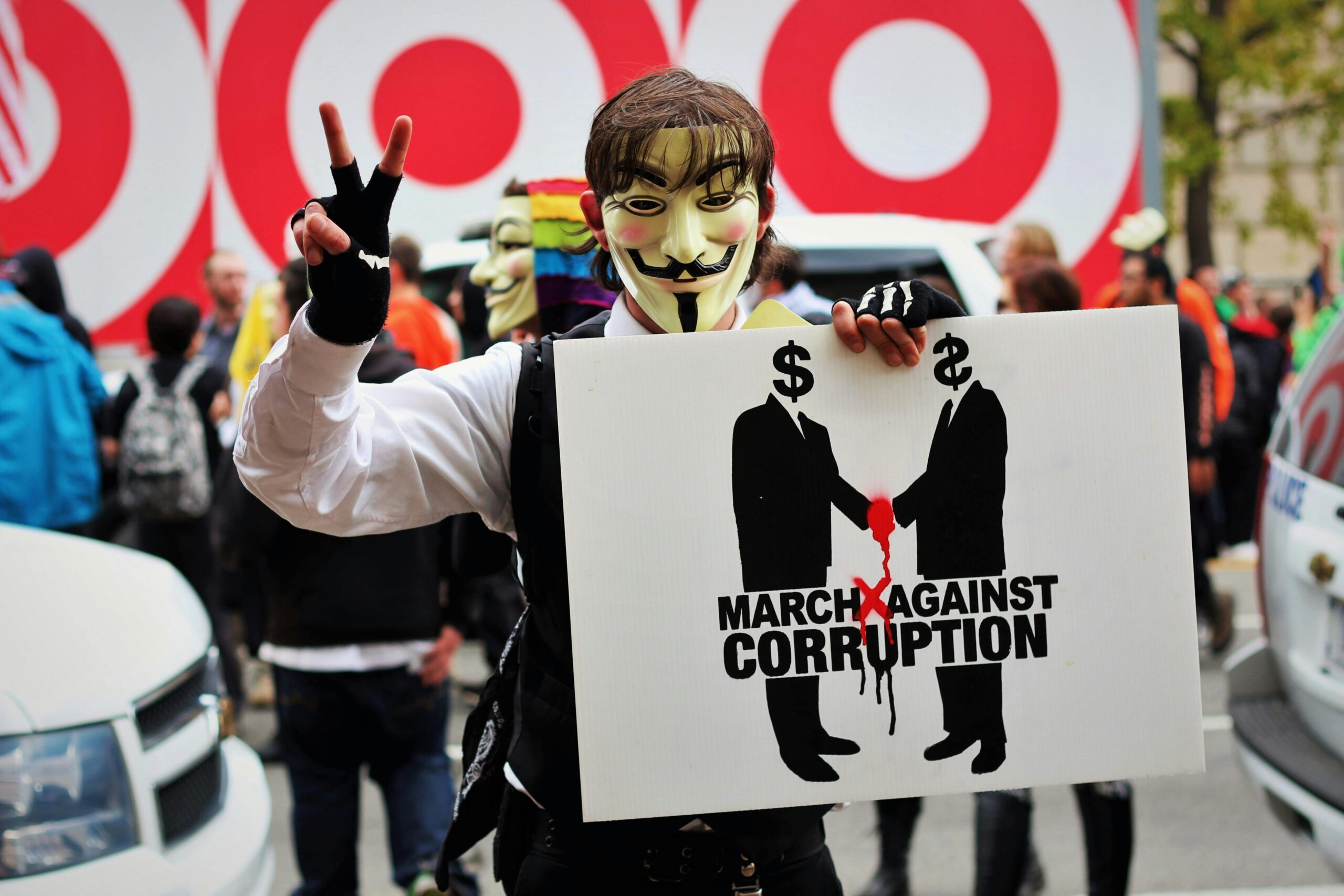 man holding sign about marching against corruption.