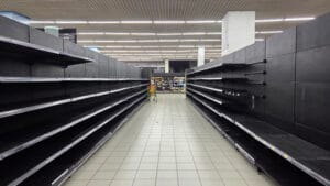 Supply disruptions during a prolonged general strike Empty grocery store aisle illustrating supply disruptions during an extended general strike